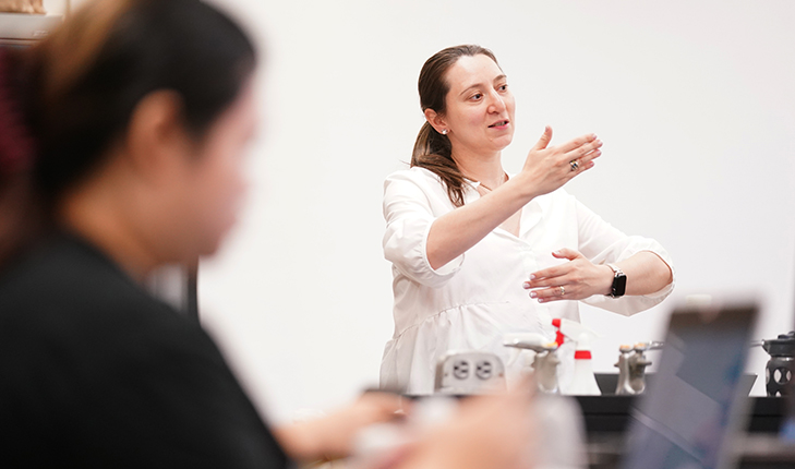 Dr. Anahit Hovhannisyan makes hand gestures during class. 